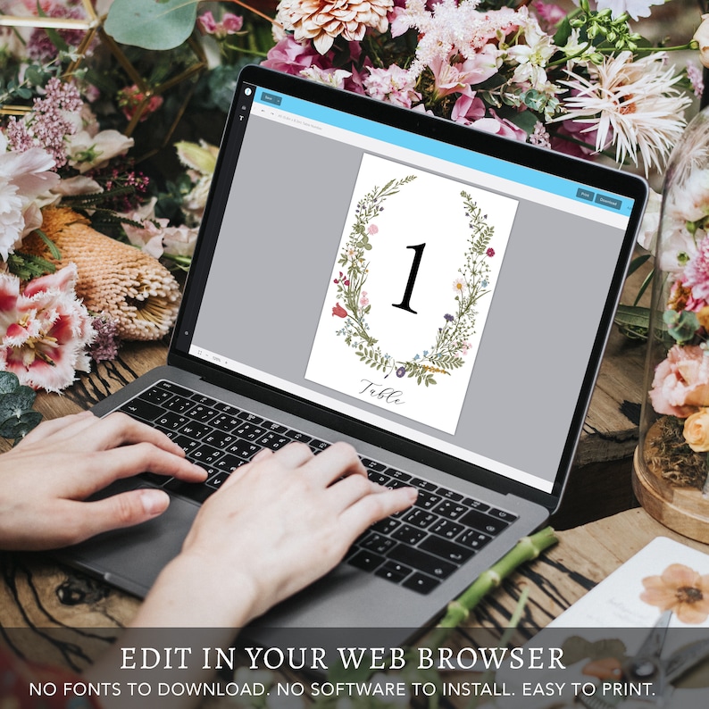 May include: A digital template for a wedding table number with a floral wreath design. The number 1 is displayed in the center of the wreath. The text "Table" is below the wreath.