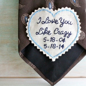 May include: A brown tie with a blue and white heart-shaped patch that says "I Love You Like Crazy 5-18-04 5-18-14".
