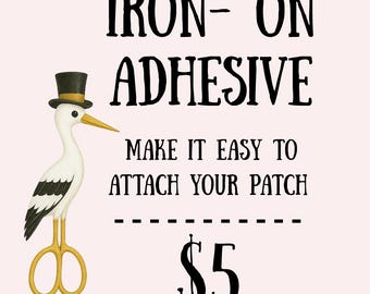 May include: Iron-on adhesive product image. The text reads "Iron-On Adhesive" and "Make it easy to attach your patch." A stork wearing a top hat and holding scissors is featured. The background is a light pink color.