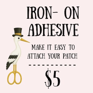 May include: Iron-on adhesive product image. The text reads "Iron-On Adhesive" and "Make it easy to attach your patch." A stork wearing a top hat and holding scissors is featured. The background is a light pink color.