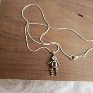 A LITTLEMAN  PENDANT ON A Chain - it is a 19&quot; Sterling Silver chain - body is Amethyst color and head cz is clear