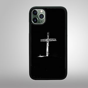 May include: Black phone case with a white cross silhouette in the center.