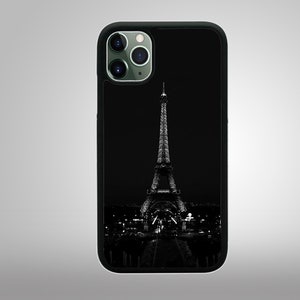 May include: Black and white phone case with a silhouette of the Eiffel Tower in Paris, France.