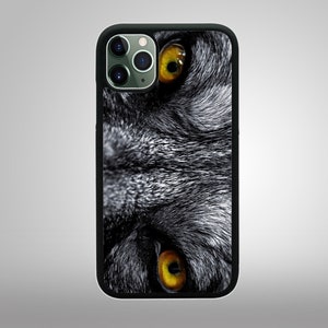 May include: Black and white phone case with a close-up of a wolf's face with yellow eyes.