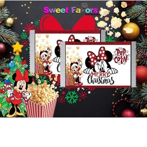 May include: Christmas-themed popcorn treat bags featuring Minnie Mouse. The bags have a red glitter border and the words "Merry Christmas" and "Popcorn". A red and white striped popcorn container is also visible.