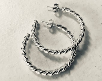 Handmade solid sterling silver twisted hoop earrings.