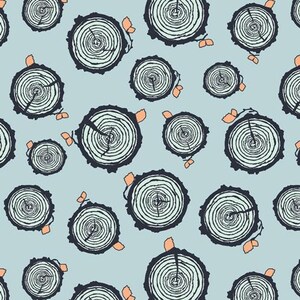 May include: A seamless pattern featuring a repeating design of tree rings in shades of blue and green on a light blue background. The tree rings are stylized and have a rustic, natural feel.