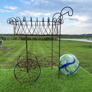 May include: A handmade wooden sign with the text "Welcome" in a handwritten style. The sign is painted white with a distressed finish, and a small green leaf is attached to the top. The sign is designed for home decor.