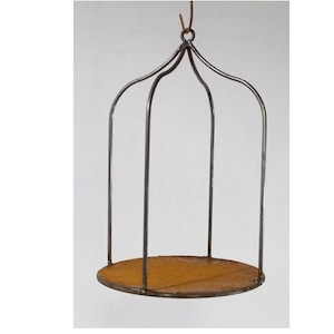 May include: A hanging metal planter with a round wooden base. The planter is made of thin metal rods and has a simple, rustic design.