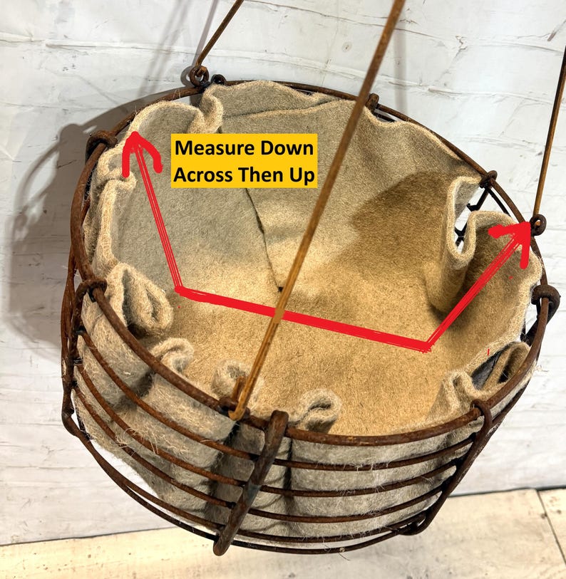 May include: A round hanging basket with a rusted metal wire frame and a beige felt liner. The interior features a yellow rectangular graphic with the black text Measure Down Across Then Up, accompanied by red arrows indicating measurement points.