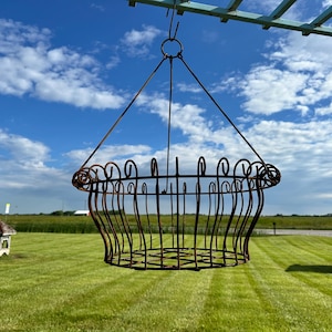 May include: A white ceramic mug with a black handle and the text "But First, Coffee" in a bold, black font. The mug is set against a blurred background, suggesting a cozy setting.