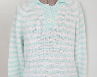 May include: A light blue and white striped sweater with a collared neckline and a single button closure. The long-sleeved sweater is displayed on a mannequin. The sweater's design features horizontal stripes.