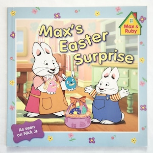 May include: A children's book titled "Max's Easter Surprise" featuring cartoon bunnies. The cover has a light blue border with floral accents and the text "As seen on Nick Jr."