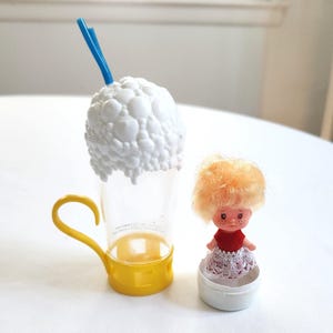 May include: A set of three ceramic mugs with a speckled, matte finish. The mugs are in shades of cream, light gray, and dark gray. Each mug has a simple, minimalist design, perfect for coffee or tea.