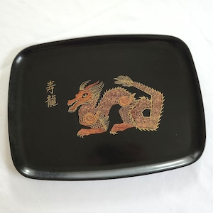 May include: Black rectangular tray with rounded corners. A detailed gold and red dragon design is centered on the tray. The tray also features Japanese characters on the left side. The tray is likely made of a glossy material.