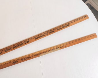 Wooden yardstick with odd number spacing on one side and pointed