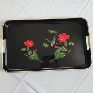 May include: Black serving tray with gold trim and a floral design featuring red hibiscus flowers and a green hummingbird.