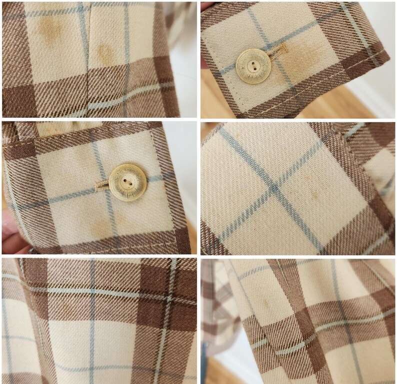 May include: Close-up of a tan, brown, and light blue plaid blazer. The blazer has a button closure and a button on the sleeve. The fabric has a woven texture. The blazer appears to be vintage.