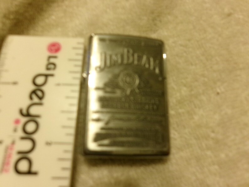 May include: A white ceramic mug with a black handle and the text "But First, Coffee" in a black, bold font. The mug is on a white surface.