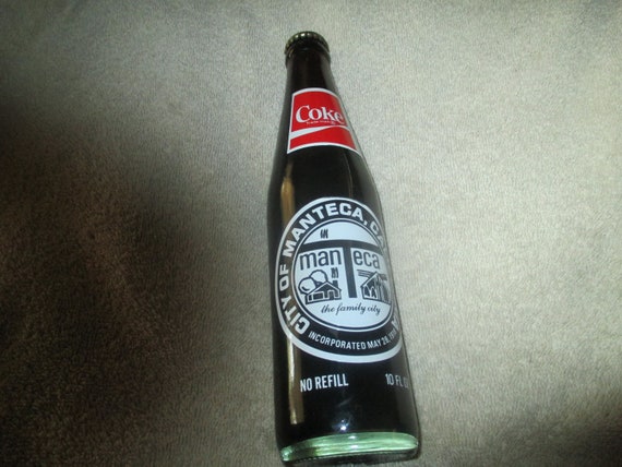 10 OZ COCA COLA COMMEMORATIVE BOTTLE - 1985 INGLES 100TH STORE OPENING