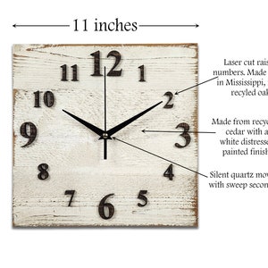 May include: A white distressed wood square clock with black hands and black raised numbers. The clock is 11 inches wide and 11 inches tall. The clock is made from recycled cedar and has a silent quartz movement with a sweep second hand.