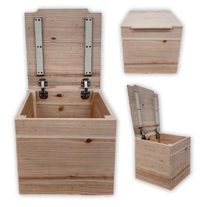 May include: A wooden storage box with a hinged lid. The lid is open and the box is empty. The box is made of light-colored wood with a natural finish.