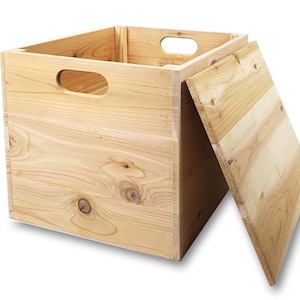 May include: A natural wood storage box with a hinged lid and two handles on the side. The lid is open and the box is empty.