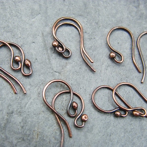 May include: Six copper earring hooks with small round balls at the end of each hook.
