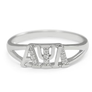 May include: A silver ring with the letters "AΨA" set with small diamonds.