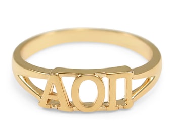 May include: A gold ring with the letters "AOII" engraved on it.