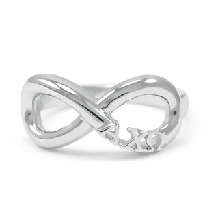 May include: Silver infinity ring with the letters "AXO" engraved inside the loop.