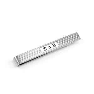 May include: Silver tie bar with a white rectangular plate with the letters "ΣΛΒ" in black.