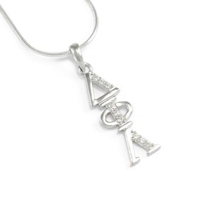May include: Silver sorority necklace with a pendant featuring the letters Delta, Phi, and Alpha, set with clear cubic zirconia stones.
