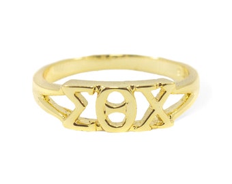 May include: A gold-colored ring with the Greek letters Sigma, Theta, and Chi.