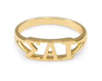 May include: Gold ring with the letters "ΣAI" in a bold, block font.