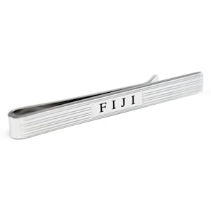 May include: Silver tie bar with a black rectangular label that says "FIJI".