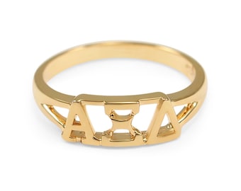 May include: A gold ring with the letters "AXA" in a cut-out design.