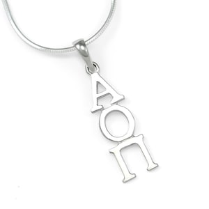 May include: Silver necklace with a pendant featuring the Greek letters A, O, and II.
