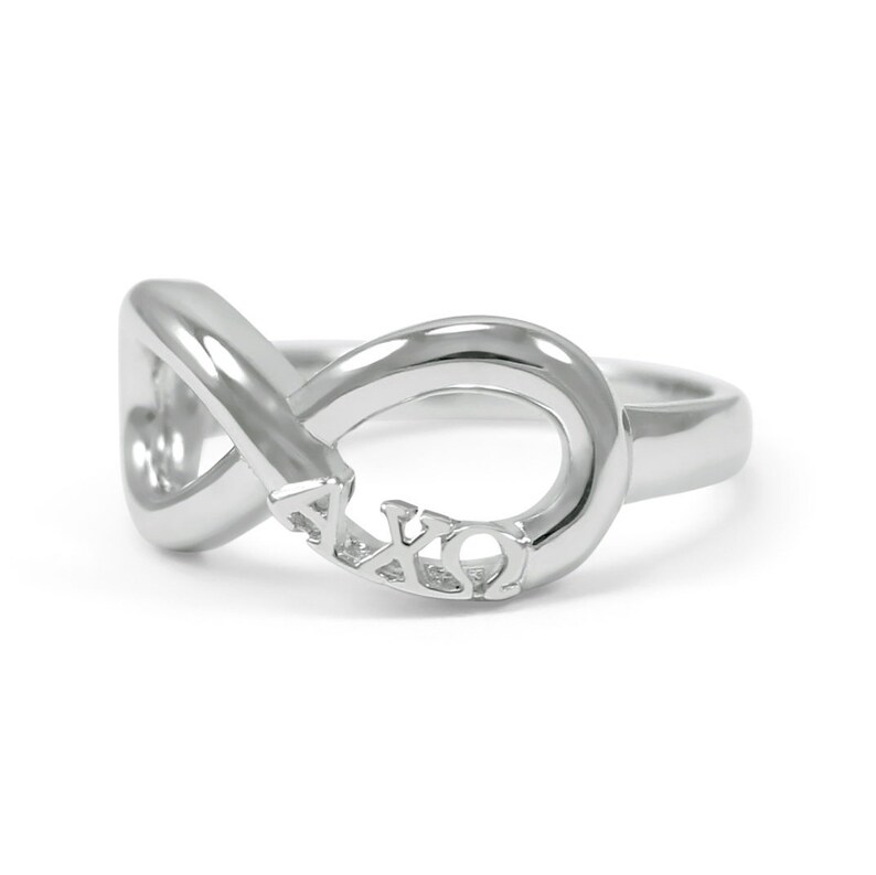 May include: Silver infinity ring with the letters AXQ engraved on the band.