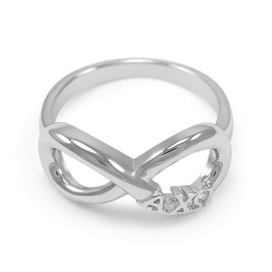 May include: A silver infinity ring with the letters "AXO" engraved on the band.
