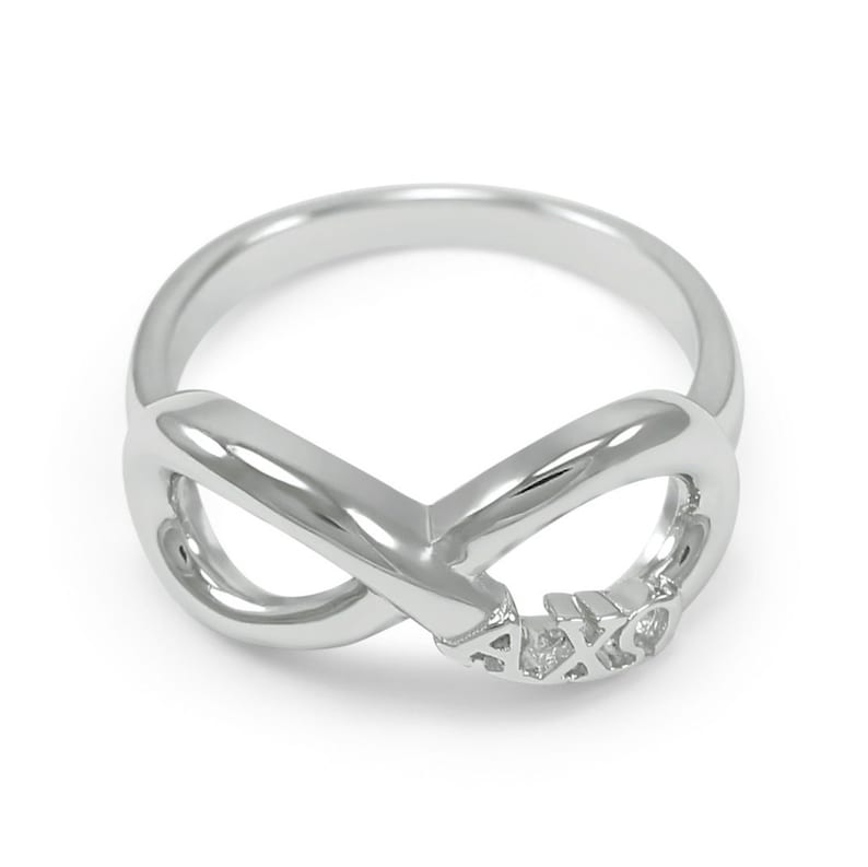 May include: A silver infinity ring with the letters "AXO" engraved on the band.
