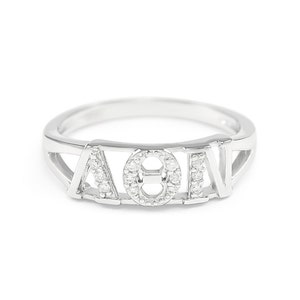 May include: A silver ring featuring the letters "AOII" set with small diamonds.