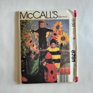 May include: Vintage McCall's sewing pattern for children's costumes. The cover features children dressed as a butterfly, bee, ladybug, and a frog. The pattern number is 8781, and the size is medium.