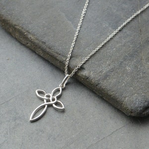 May include: A silver Celtic knot cross pendant necklace. The pendant is a simple design with a knot in the centre of the cross. The necklace is on a silver chain.