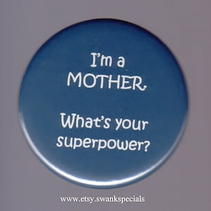 May include: A blue round button with white text that reads "I'm a MOTHER. What's your superpower?" and a website address at the bottom.