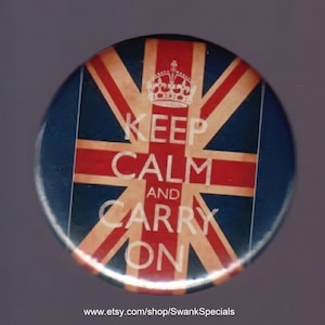 May include: A round button featuring the Union Jack flag design with the words "KEEP CALM AND CARRY ON" in white text. A crown is above the words. The button has a blue border and a glossy finish.