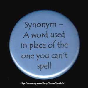 May include: A blue round button with the text "Synonym - A word used in place of the one you can't spell" and the website address "http://www.etsy.com/shop/SwankSpecials".