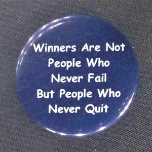 May include: A navy blue button with white text that reads: "Winners Are Not People Who Never Fail But People Who Never Quit."