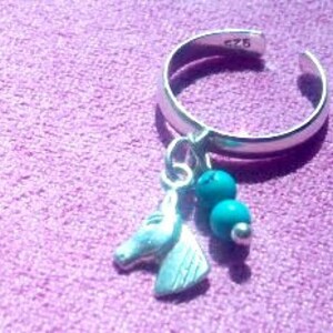 May include: Silver toe ring with a turquoise charm and a horse head pendant.