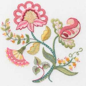 May include: Embroidered floral design featuring pink, red, green and yellow flowers and leaves. The design is stitched onto a white fabric background.